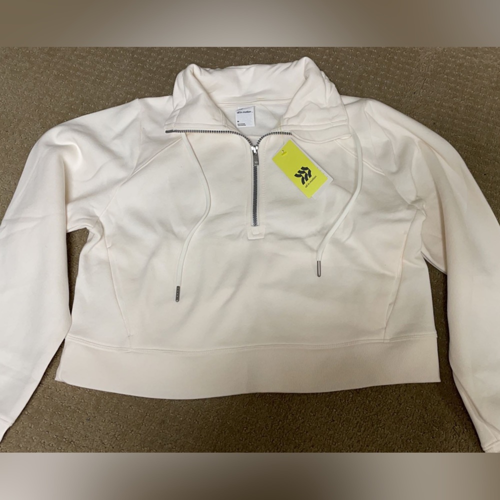 Size medium women's, color cream, half zip cropped, brand new with tags